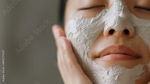 South Korean Woman Using Bentonite Clay Mask in Serene Skincare Routine for Acne Treatment and Oil Absorption photo