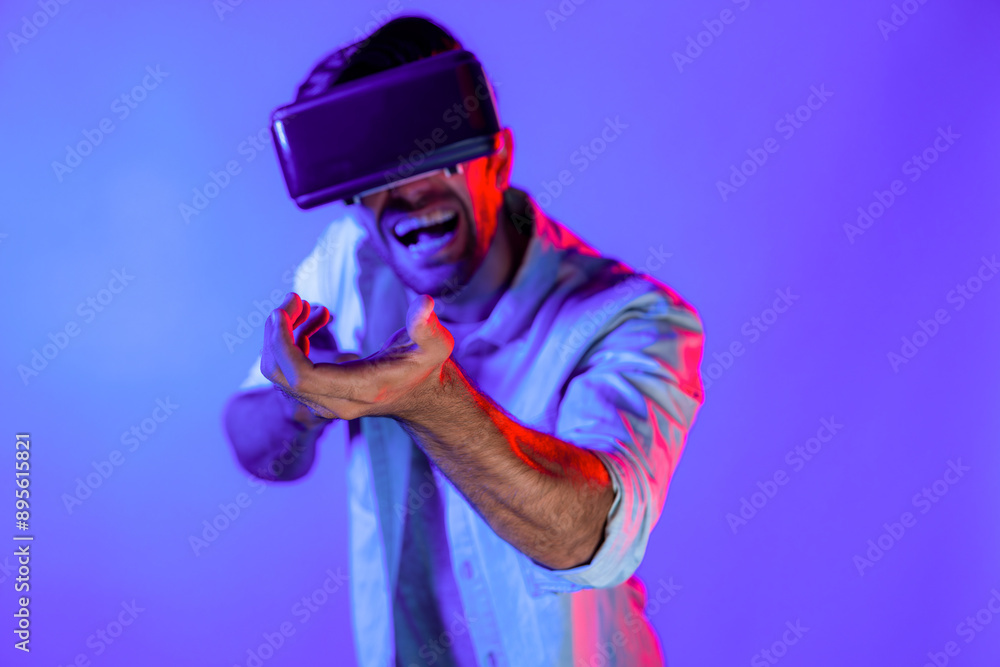 Caucasian smart man wearing VR glass and moving gesture holding gun. Gamer using future digital virtual reality headset or futuristic innovation to enter meta world or playing action game. Deviation. Caucasian smart man wearing VR glass and moving gesture holding gun. Gamer using future digital virtual reality headset or futuristic innovation to enter meta world or playing action game. Deviation.