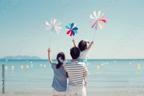 Family Playing With Pinwheels On Beach