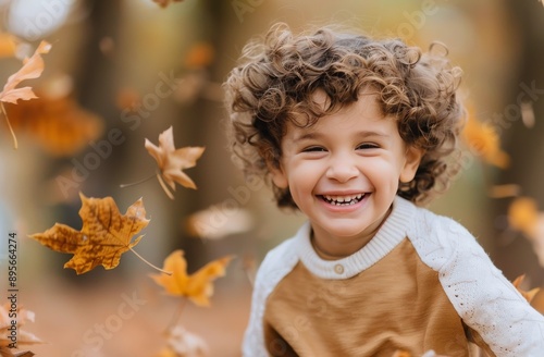 Smiling Child in Autumn Leaves