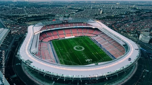 Stadium above the scenery with football field spotlights and a bird's-eye view of the city.