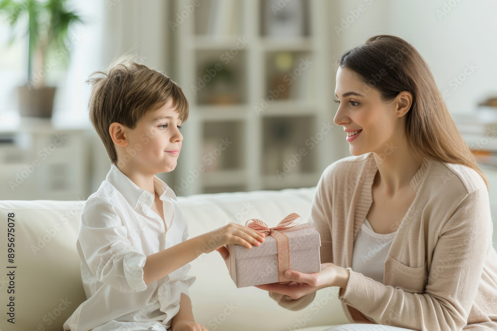 Celebrate mother's day with a heartwarming image of a little boy joyfully presenting a gift box to his smiling mother Celebrate mother's day with a heartwarming image of a little boy joyfully presenting a gift box to his smiling mother