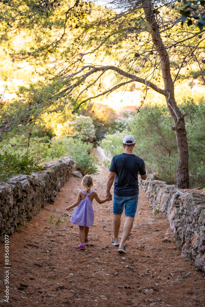 Father and daughter in shore in the bay of Uvala Gradina near the town of Vela Luka on the island of Korcula in Croatia