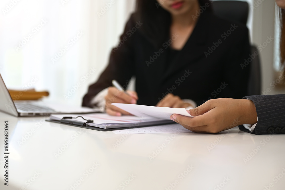 Cropped shot of businesswoman in formal suit explaining strategy to her colleague at office Cropped shot of businesswoman in formal suit explaining strategy to her colleague at office