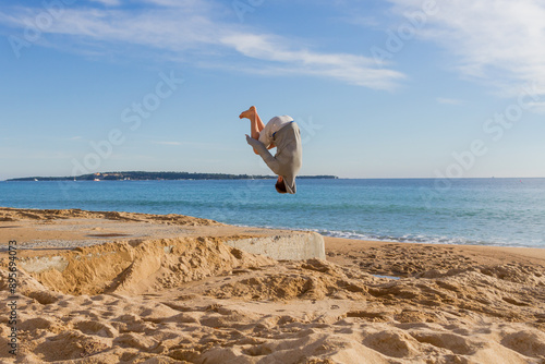 Somersault on beach