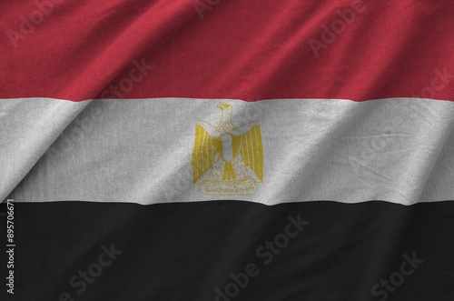 Egypt flag depicted on folded wavy fabric of old cloth close up photo