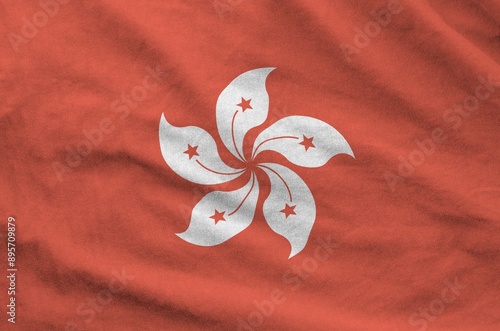 Hong kong flag depicted on folded wavy fabric of old cloth close up photo