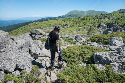 Traveler Woman standing on a rocks in the summer mountain .Vitosha Mountain ,Bulgaria 