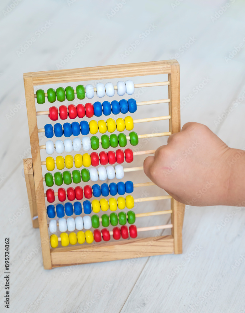 Kid hand playing with Wooden Educational Counting Toy With Beads Kid hand playing with Wooden Educational Counting Toy With Beads