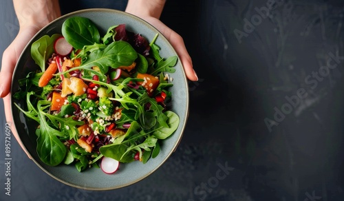 Hands Holding Bowl of Fresh Salad