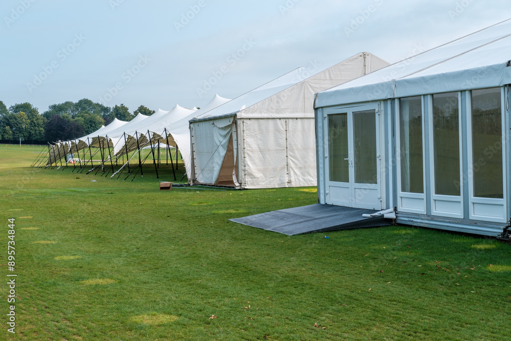 Obraz premium Marquee or gazebos in a field for cover at event.
