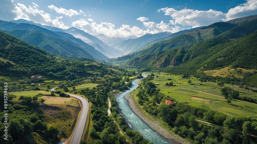 Aerial view of a picturesque road following a river in the Alpine landscape of Svanetia, Georgia Aerial view of a picturesque road following a river in the Alpine landscape of Svanetia, Georgia