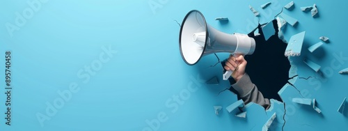Wallpaper Mural A Hand Holding Megaphone or Loudspeaker Breaking Through a Blue Background. Creative Banner Design with Blank Copyspace for Custom Advertising and Messaging. Torontodigital.ca