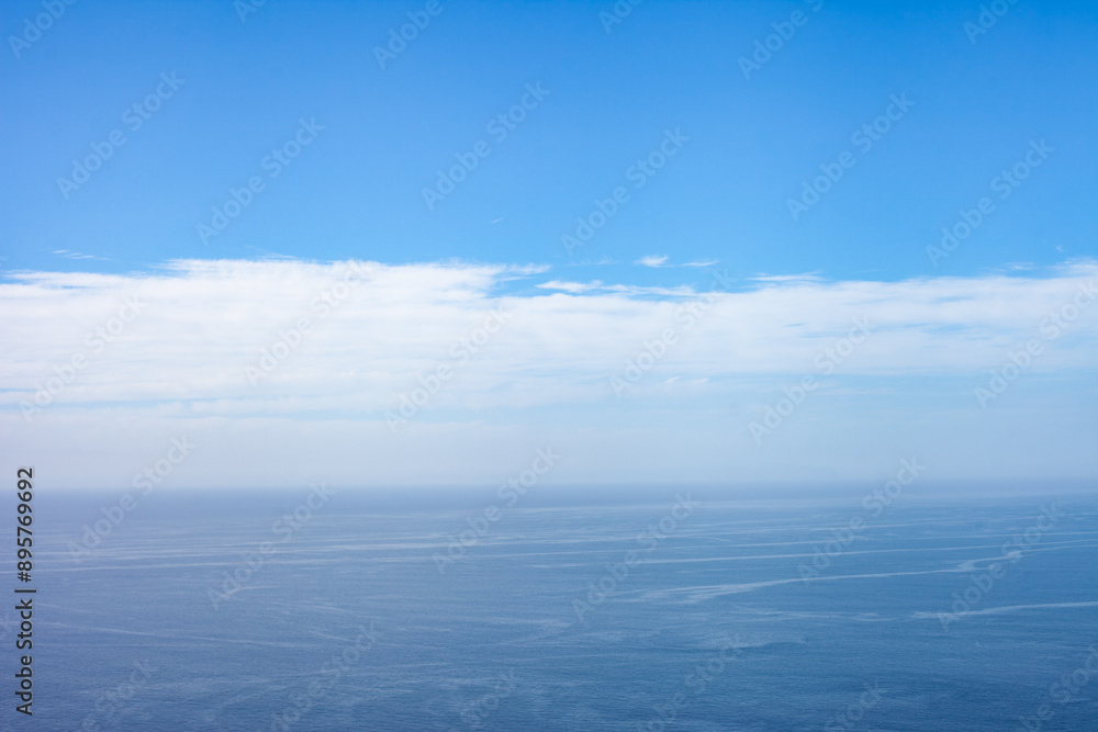 horizon line in ocean and blue sky with clouds, horizontal minimal landscape with copy space horizon line in ocean and blue sky with clouds, horizontal minimal landscape with copy space