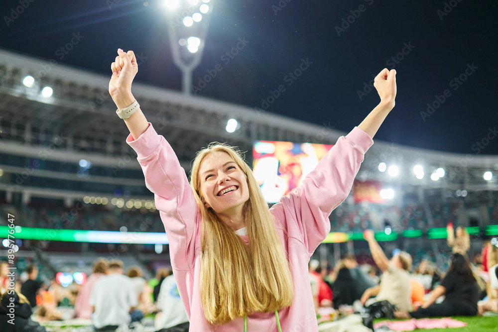 Fototapeta premium A woman came to the stadium to watch the match broadcast online