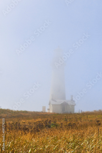 Yaquina Head Lighthouse on the Oregon Coast of the United States, established in 1873, seen in the mist. 