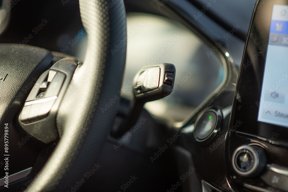 A closeup image displaying the steering wheel inside a vehicle A closeup image displaying the steering wheel inside a vehicle