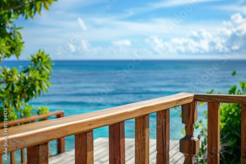 Close-up Empty Wooden balcony of a luxurious hotel resort with a view of a paradise beach with blue water
