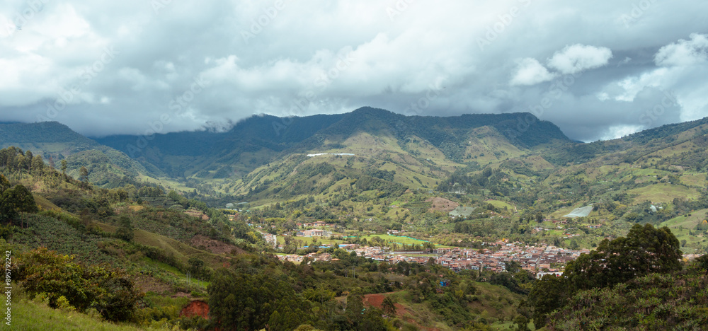 Obraz premium Cityscape of Jardin, Jardín, Antioquia, Colombia. Awesome landscape with the green Andes Mountains and a dramatic cloudy sky.