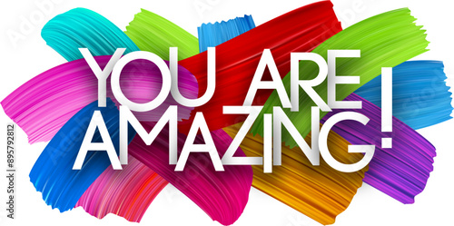 You are amazing paper word sign with colorful spectrum paint brush strokes over white. Vector illustration.