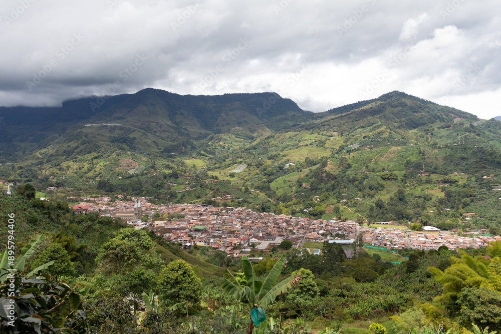 Obraz premium Cityscape of Jardin, Jardín, Antioquia, Colombia. Awesome landscape with the green Andes Mountains and a dramatic cloudy sky.