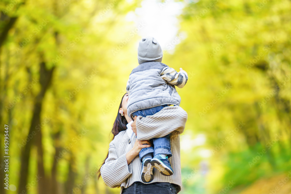 Mother holding child in autumn forest Mother holding child in autumn forest