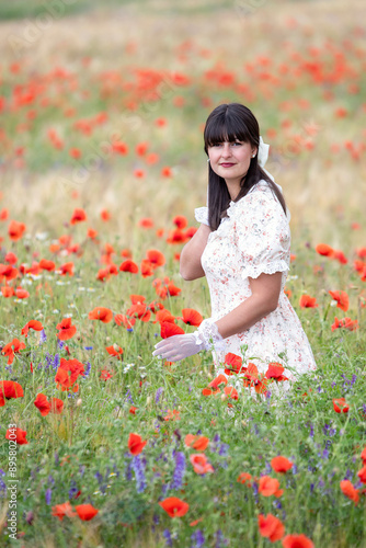 Pretty lady with hat, white gloves between poppies photo