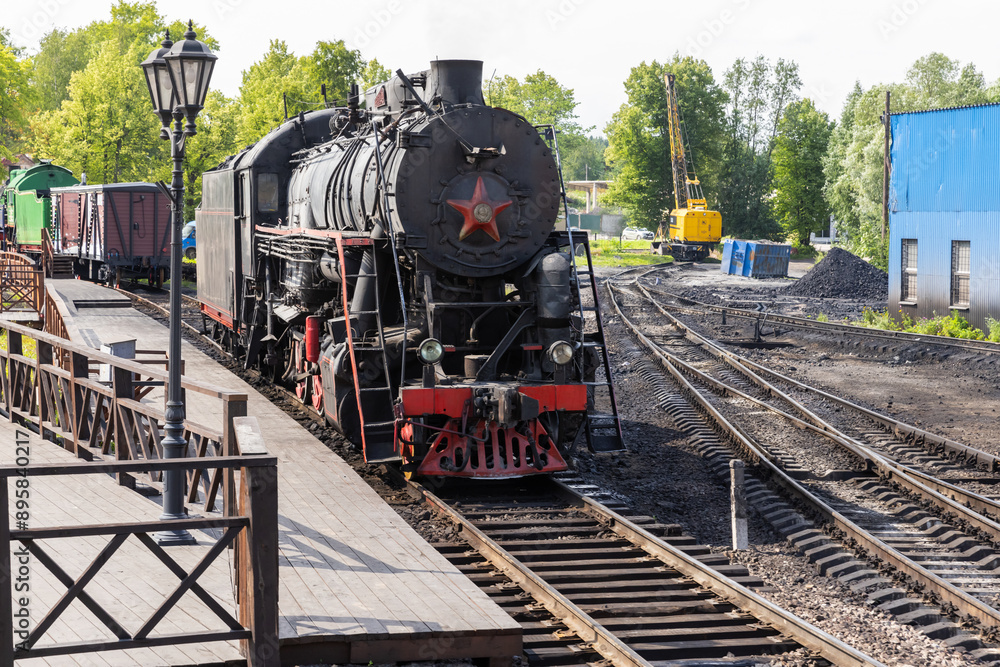 Retro passenger train with black steam locomotive from USSR times Retro passenger train with black steam locomotive from USSR times