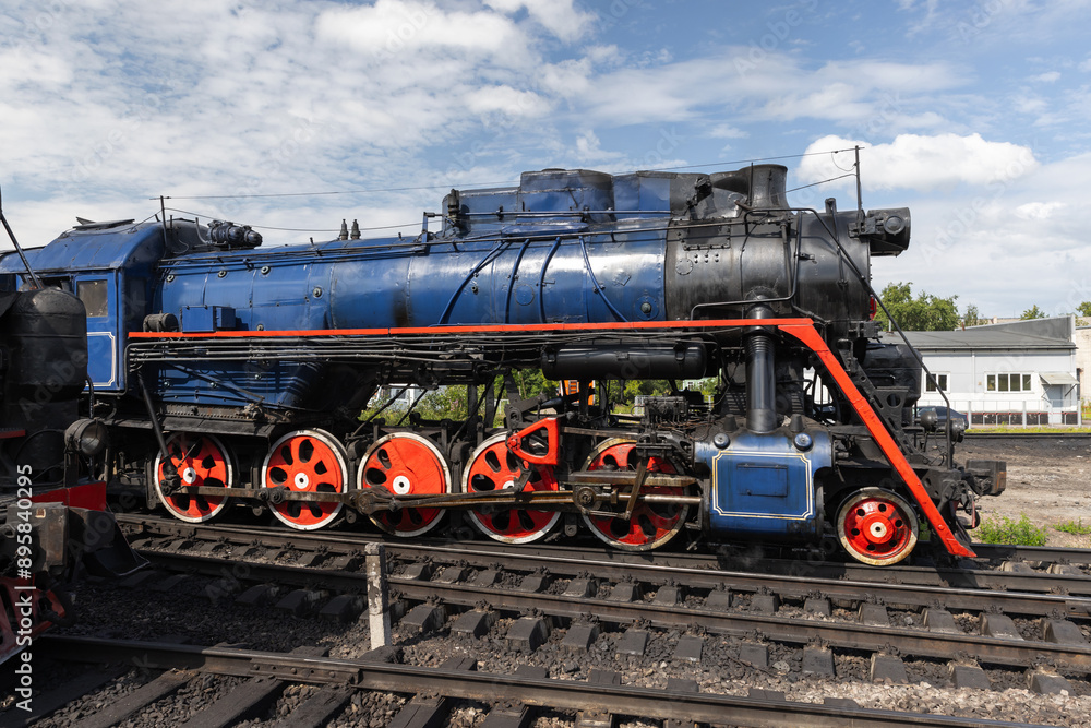Naklejka premium Vintage black steam locomotive with blue and red details