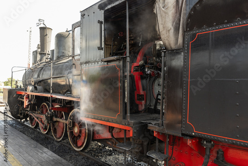 Fotografie Vintage black steam locomotive with red details, closeup