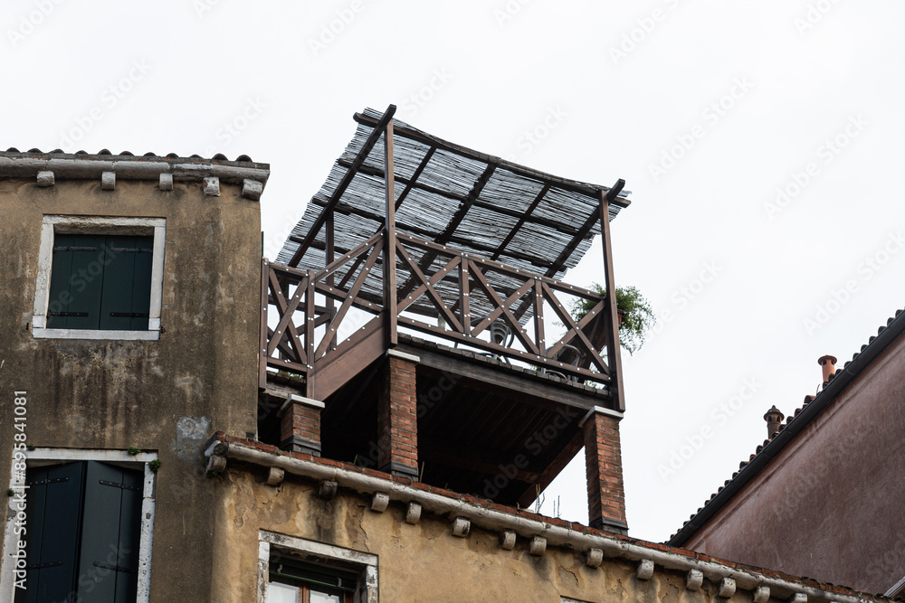 Small wooden pavilion on house roof in Venice Small wooden pavilion on house roof in Venice