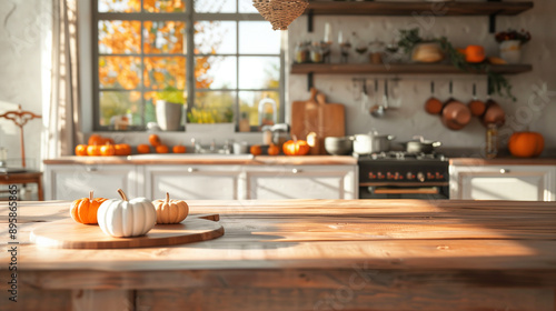 Wood tabletop with room for text in a fall kitchen setting, decorated with pumpkins.