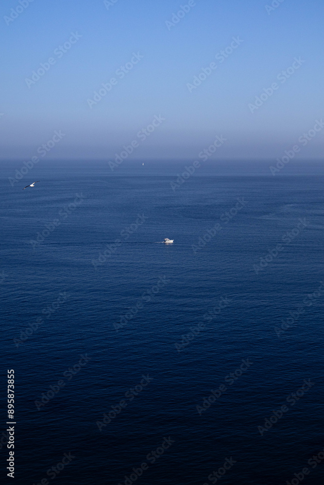 Lonely boat in the middle of the ocean Lonely boat in the middle of the ocean