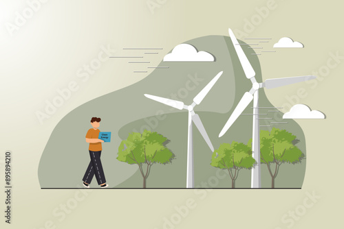A man is walking in front of a wind farm