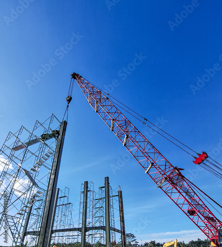 Selective focus. Structural steel under construction. Steel structure work. Blue sky background. Indonesia. photo