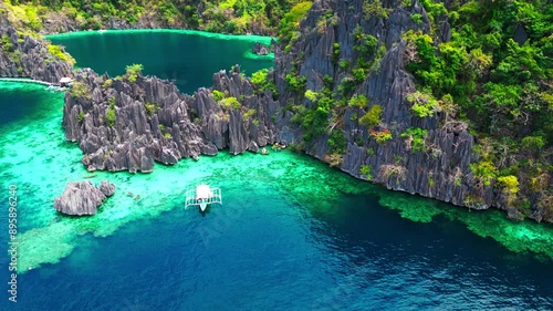 Kayangan Lake In Philippines Drone Aerial Pan Down To Tourist Boat In Lagoon photo