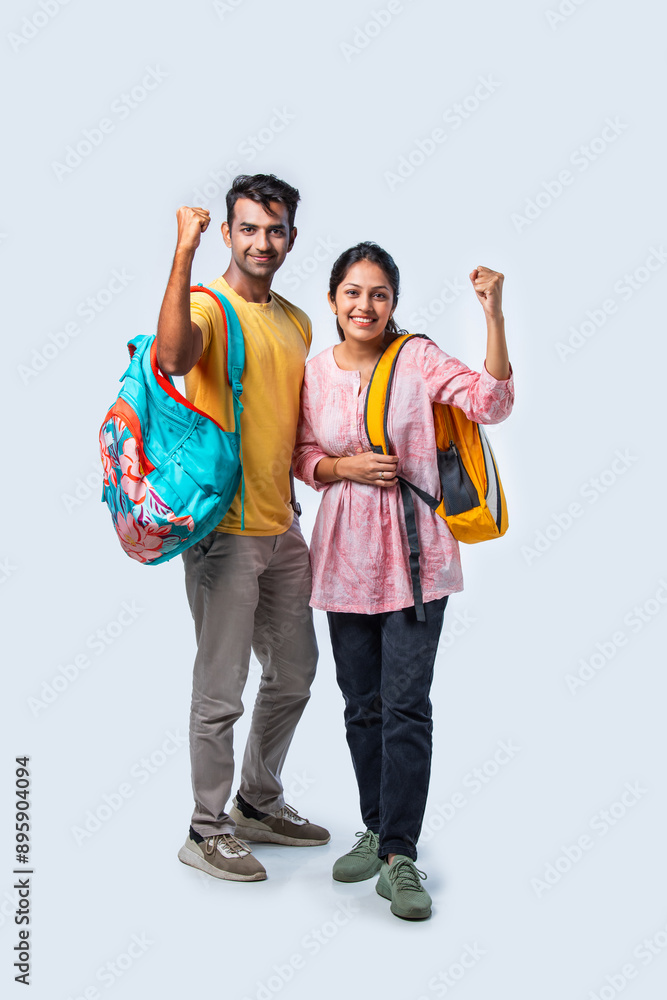 Obraz premium Two Happy Indian College Students with Bags and Laptop, Isolated on White Background
