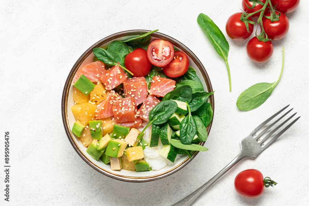 Salmon bowl with spinach, rice, avocado, tomato, cucumbers on a white background, top view. Poke bowl, healthy eating Salmon bowl with spinach, rice, avocado, tomato, cucumbers on a white background, top view. Poke bowl, healthy eating