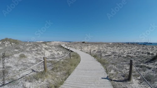 Zoom-in HD video of a wooden paved path protecting the eco-system and sand dunes on the island Formentera in Spain photo