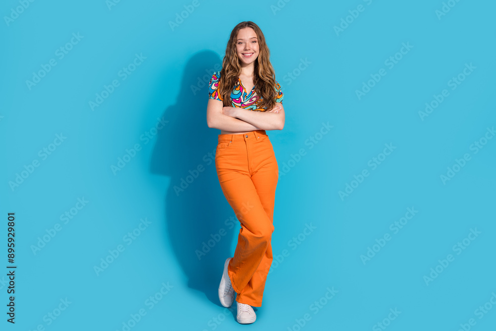 Naklejka premium Full size photo of nice young girl posing empty space wear top isolated on blue color background