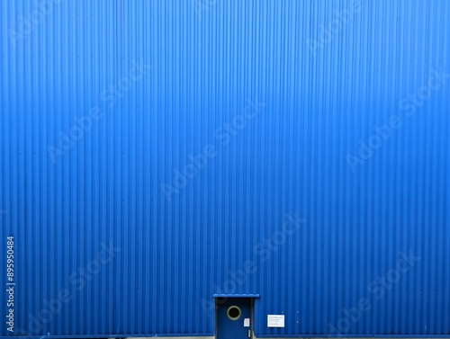 Blue door on blue metal sheet wall