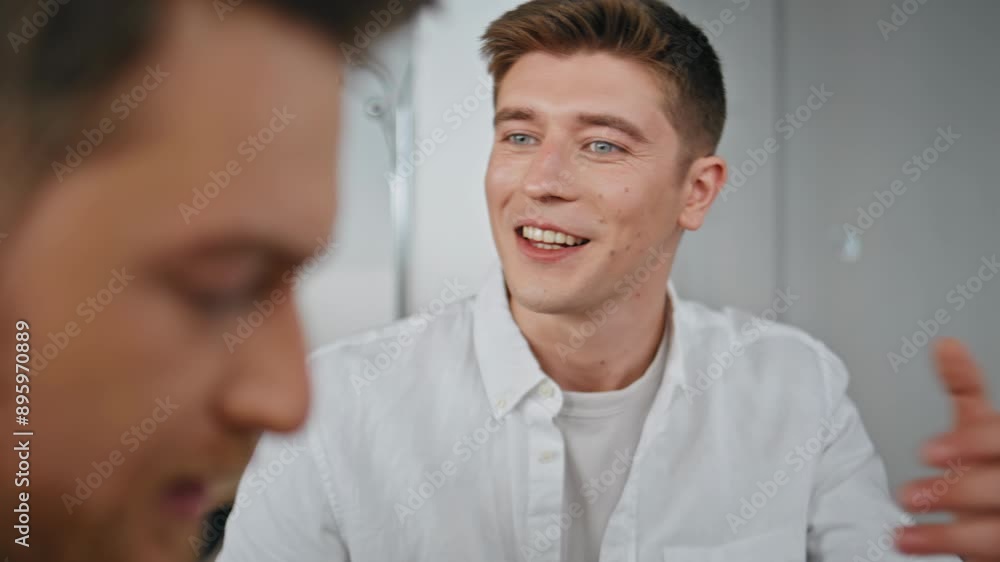 Closeup smiling partners talking at office. Colleagues brainstorming together Closeup smiling partners talking at office. Colleagues brainstorming together