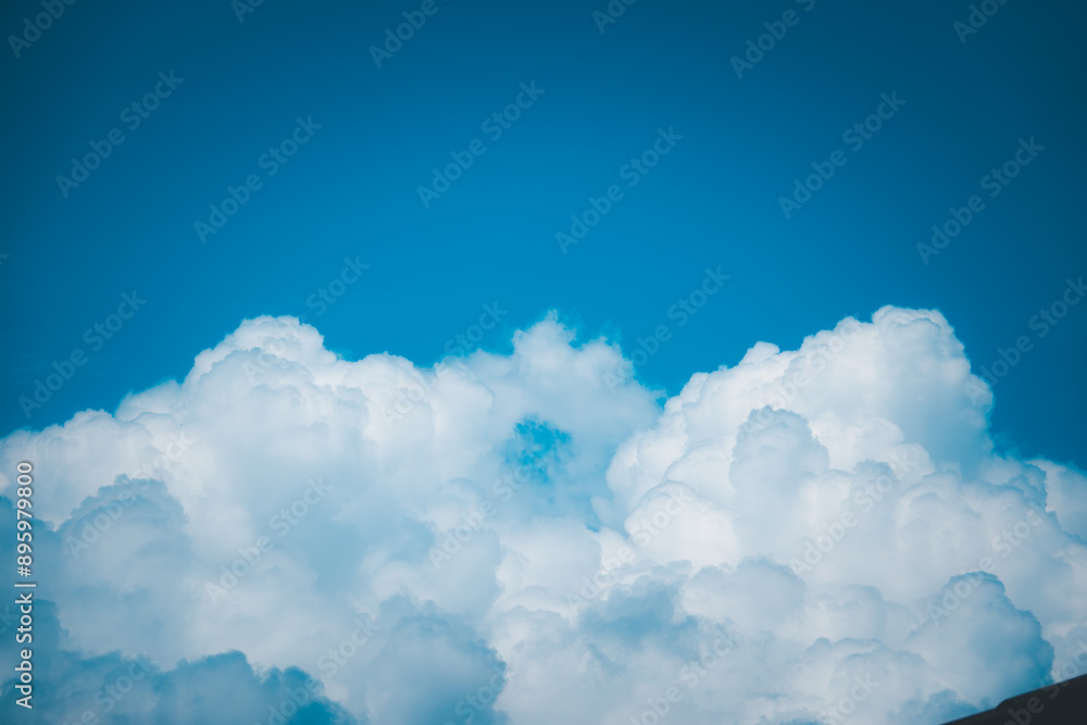 The sky is blue and the clouds are white. The clouds are scattered throughout the sky and there are no visible storm clouds. The sky is clear and the sun is shining brightly The sky is blue and the clouds are white. The clouds are scattered throughout the sky and there are no visible storm clouds. The sky is clear and the sun is shining brightly