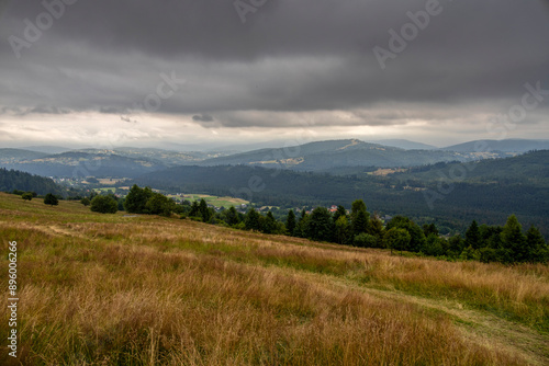 Landscape from a meadow on a slope on Ochodzita in Koniakow under a cloudy sky on a summer afternoon