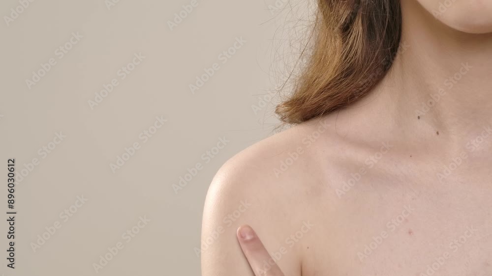 Young woman posing at camera touching smooth skin on shoulder, isolated on white background. Natural beauty and skin care concept Young woman posing at camera touching smooth skin on shoulder, isolated on white background. Natural beauty and skin care concept
