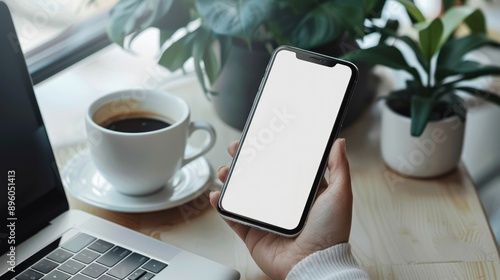 Wallpaper Mural Mockup, using blank screen mobile phone with laptop and cup of coffee on table. finger touching on the cell phone screen, template for mobile app design or advertisement  Torontodigital.ca