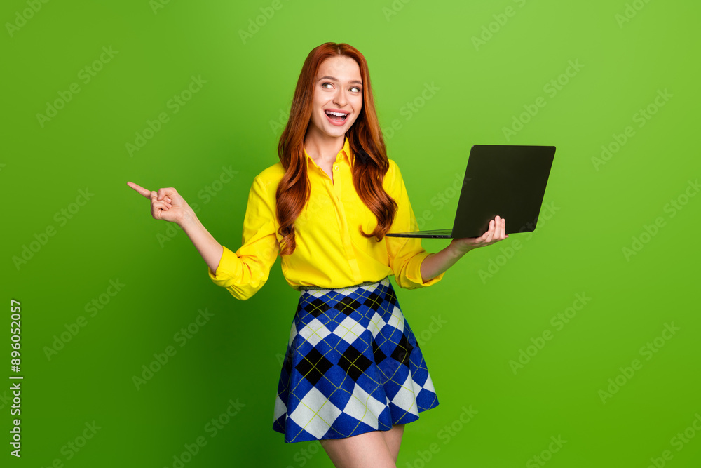 Photo of adorable cute woman wear yellow trendy clothes recommend empty space isolated on green color background Photo of adorable cute woman wear yellow trendy clothes recommend empty space isolated on green color background