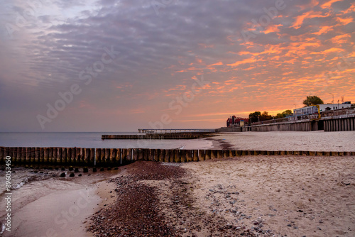 Obraz na płótnie View of sand beach with wooden breakwaters on the Baltic Sea coast on sunrise in Zelenogradsk. Russia w salonie