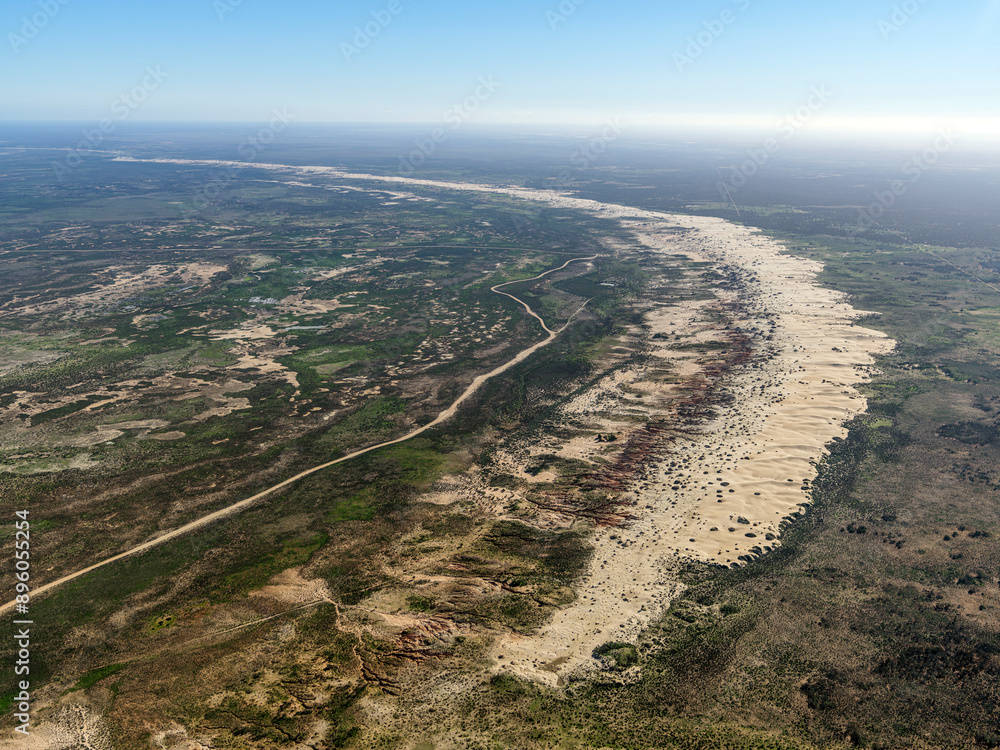 Aerial view of vast desert landscape with sand dunes and clear sky, lake mungo national park, new south wales, australia. Aerial view of vast desert landscape with sand dunes and clear sky, lake mungo national park, new south wales, australia.