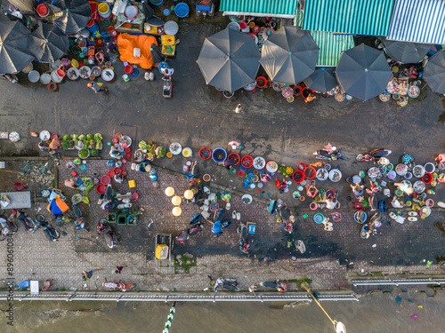 Aerial view of vibrant traditional street market with busy vendors and bustling city life, Ho Chi Minh City, Vietnam.
